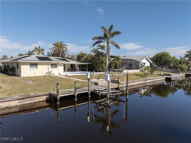 view of dock with a water view and a yard