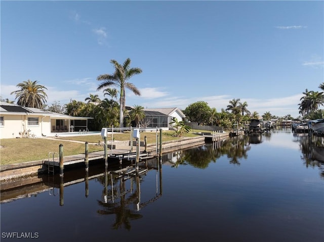 view of dock featuring a water view and a lawn