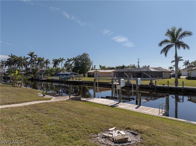 view of dock with a yard and a water view