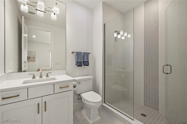 bathroom featuring tile patterned flooring, vanity, toilet, and a shower with shower door