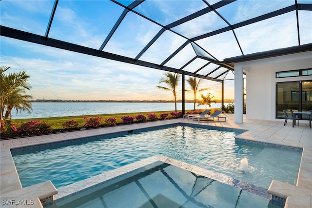 view of swimming pool featuring a lanai, a patio area, an in ground hot tub, and a water view