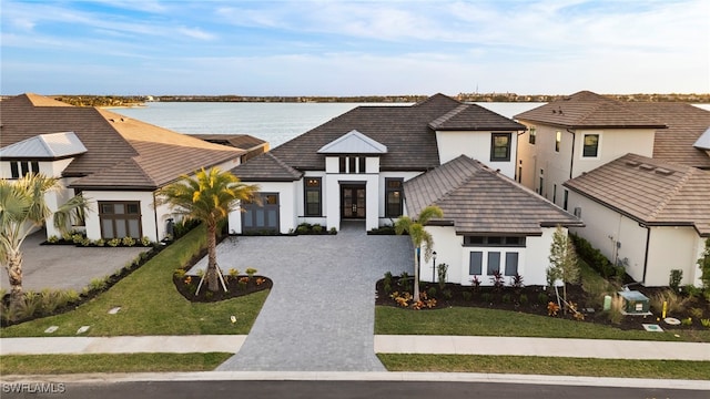 view of front of property with a water view and a front yard