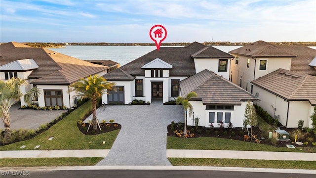 view of front of property with a water view