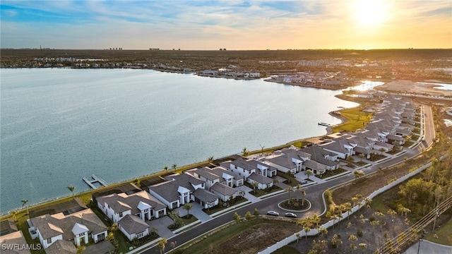 aerial view at dusk with a water view