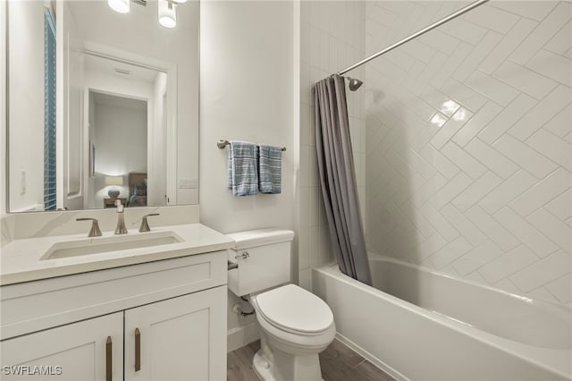 full bathroom featuring vanity, wood-type flooring, shower / bath combo, and toilet