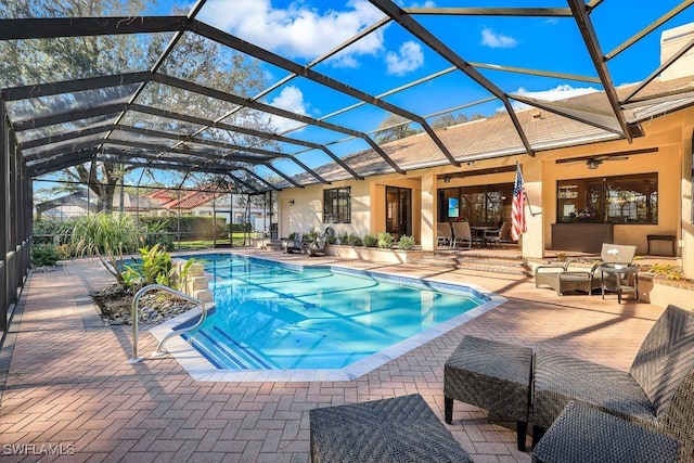 4556 Pond Apple Dr N, Naples, FL 34119 - outdoor pool with a patio area, ceiling fan, and glass enclosure