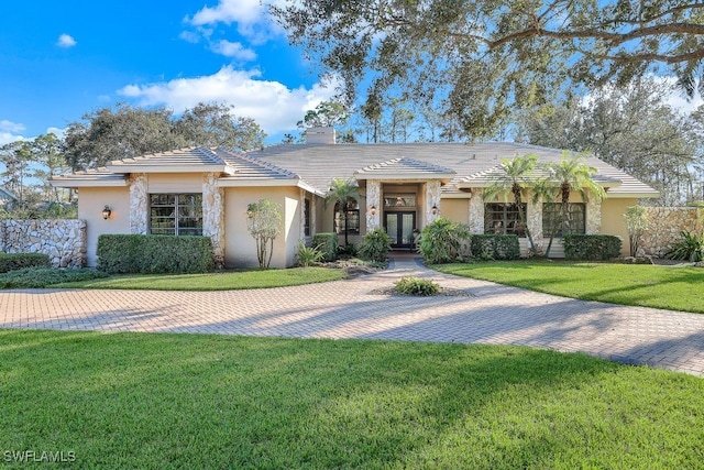 single story home with a front yard and french doors