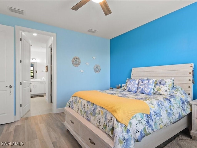 bedroom with ensuite bath, ceiling fan, and light hardwood / wood-style floors