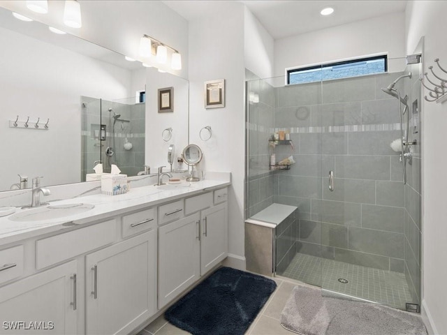 bathroom featuring tile patterned flooring, vanity, and a shower with door