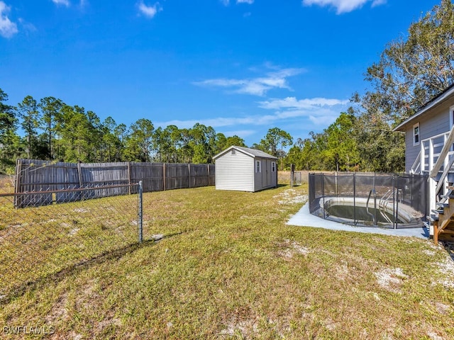 view of yard with a storage shed and a pool