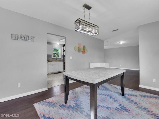 dining room with sink and dark hardwood / wood-style floors