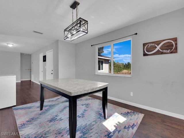 unfurnished dining area with dark hardwood / wood-style flooring