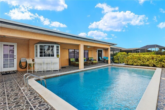 view of swimming pool with an outdoor living space, ceiling fan, and a patio area