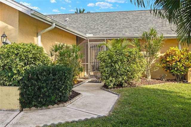 property entrance with a yard