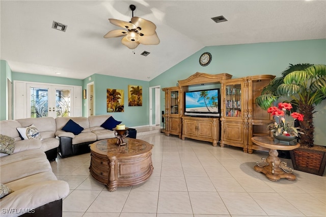 living room featuring ceiling fan, french doors, light tile patterned floors, and lofted ceiling