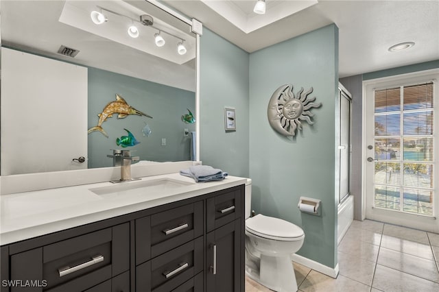 full bathroom featuring tile patterned flooring, vanity, toilet, and combined bath / shower with glass door