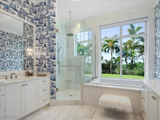 bathroom featuring vanity, ornamental molding, and shower with separate bathtub