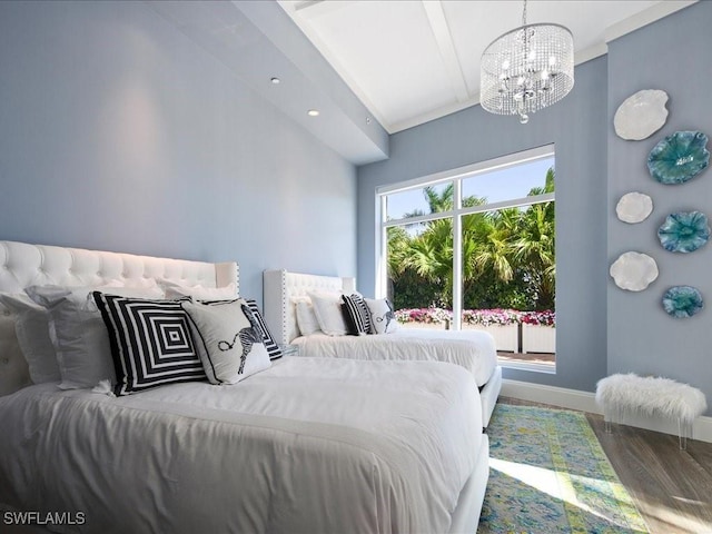 bedroom with hardwood / wood-style floors and a notable chandelier