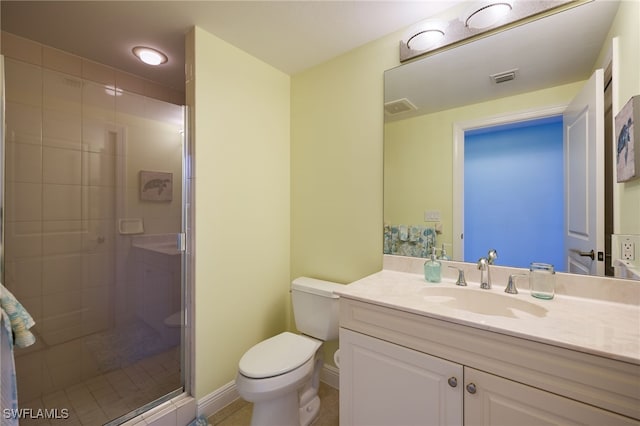 bathroom featuring tile patterned floors, vanity, an enclosed shower, and toilet