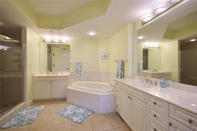 bathroom featuring tile patterned flooring, vanity, and plus walk in shower