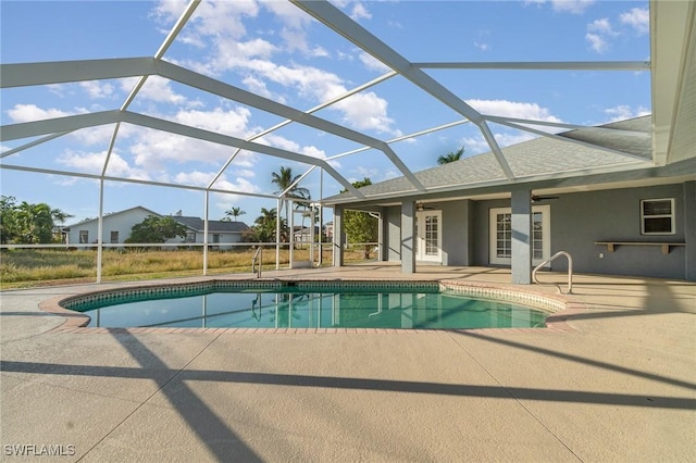 view of swimming pool with a patio and glass enclosure