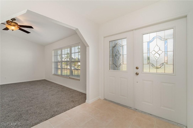 entrance foyer featuring light carpet and ceiling fan