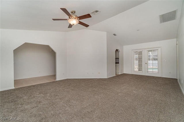 unfurnished living room with light carpet, vaulted ceiling, and ceiling fan