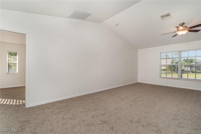 empty room featuring carpet, ceiling fan, and lofted ceiling