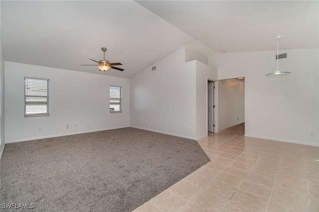 carpeted empty room with vaulted ceiling, a wealth of natural light, and ceiling fan