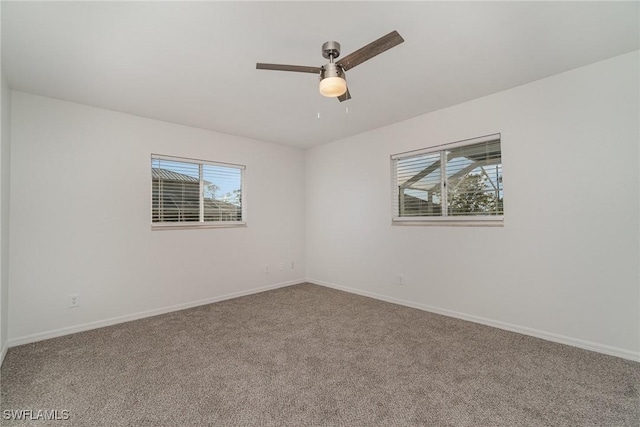 unfurnished room featuring carpet, a wealth of natural light, and ceiling fan