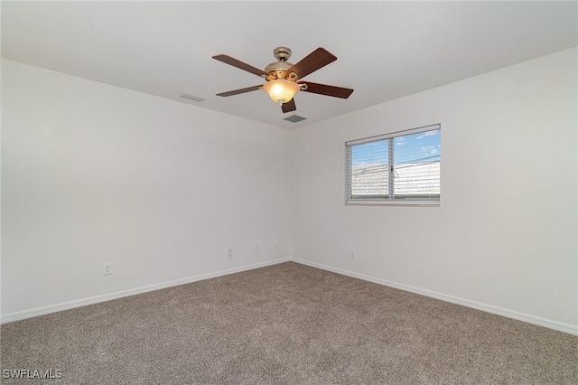 empty room featuring ceiling fan and carpet