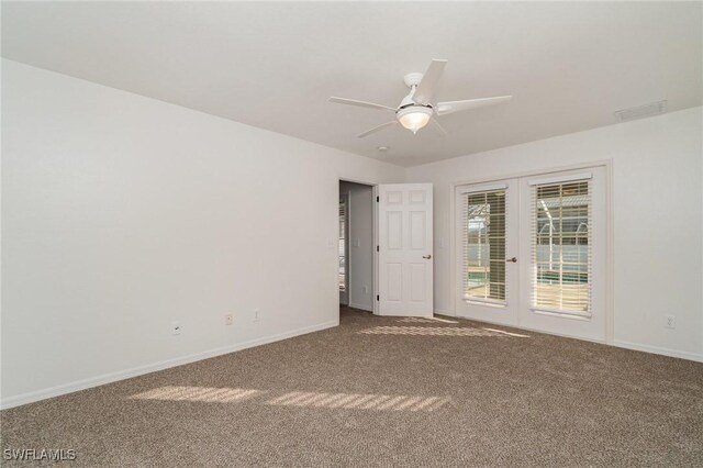 spare room with french doors, carpet floors, and ceiling fan