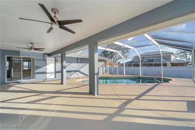 view of pool featuring glass enclosure, ceiling fan, and a patio area