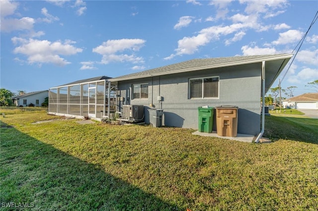 back of house featuring a yard, cooling unit, and a lanai