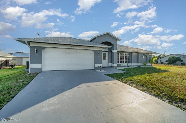 ranch-style house featuring a garage and a front lawn