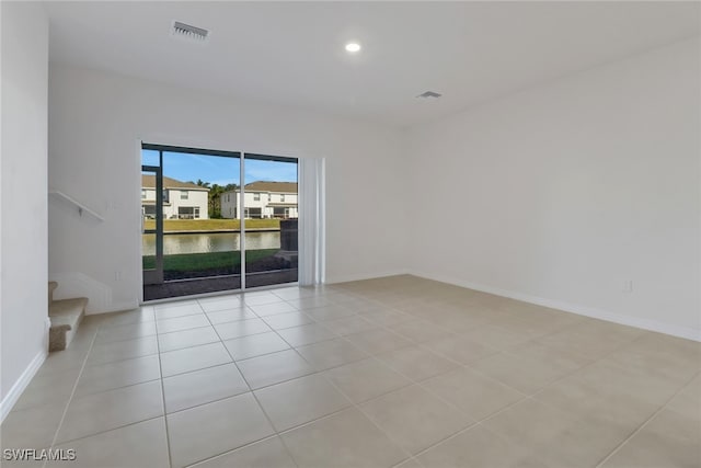 tiled empty room with a water view