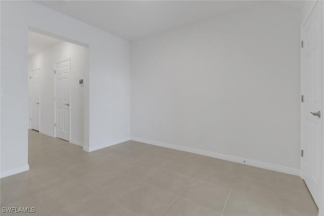 spare room featuring light tile patterned floors