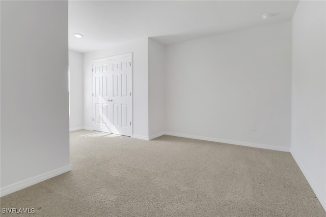 empty room with light colored carpet