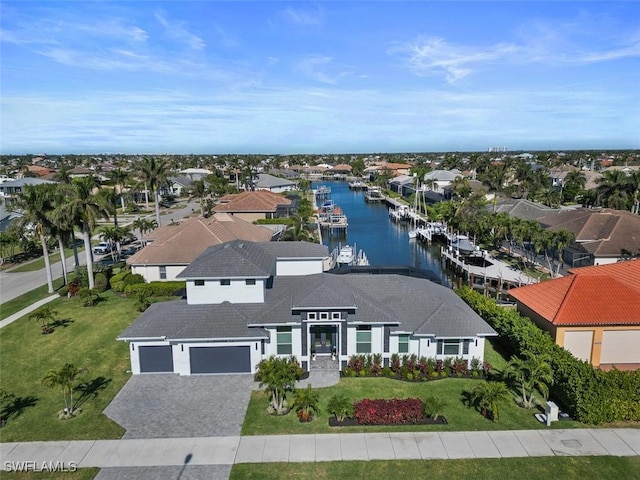 drone / aerial view featuring a water view and a residential view