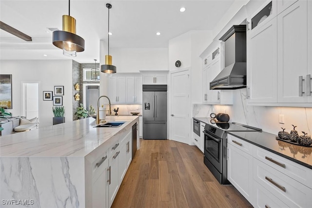 kitchen featuring stainless steel appliances, a sink, decorative light fixtures, and white cabinets