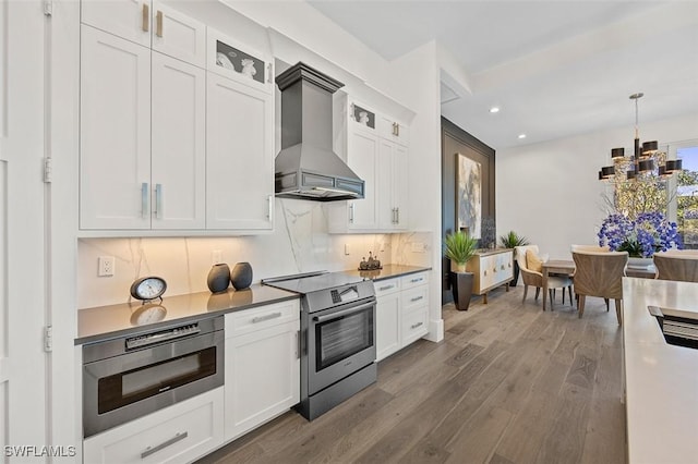 kitchen featuring stainless steel appliances, white cabinets, premium range hood, and glass insert cabinets