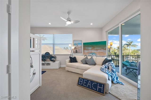 carpeted living area featuring recessed lighting, a ceiling fan, and baseboards