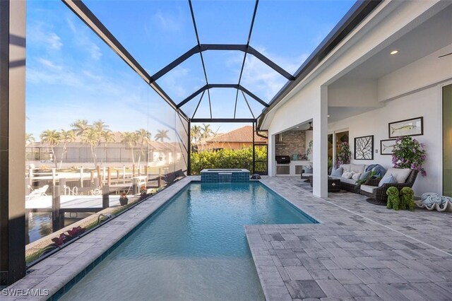 view of swimming pool featuring a patio, a pool with connected hot tub, an outdoor hangout area, and glass enclosure