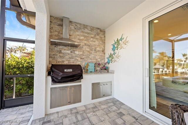 view of patio / terrace featuring a grill and exterior kitchen