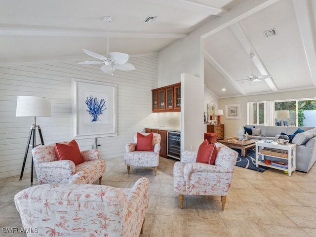 living room with high vaulted ceiling, beam ceiling, and beverage cooler