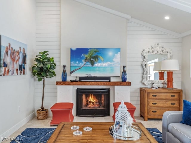 living room featuring wood walls, light tile patterned flooring, and lofted ceiling