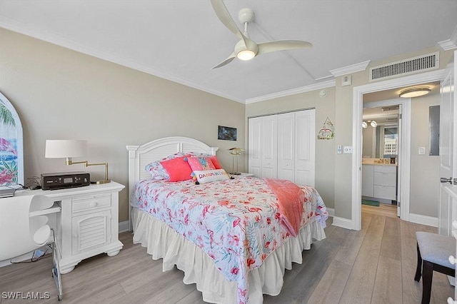 bedroom with a closet, light hardwood / wood-style floors, ceiling fan, and crown molding