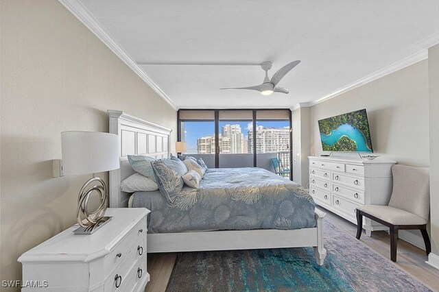 bedroom featuring access to exterior, wood-type flooring, ceiling fan, and ornamental molding