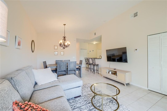 living room with light tile patterned floors and a notable chandelier