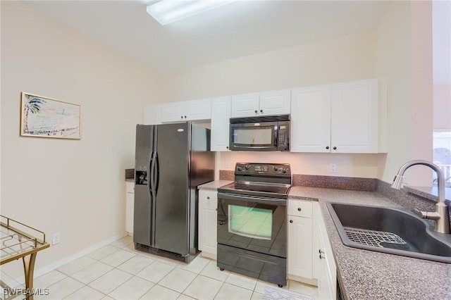 kitchen featuring white cabinetry, sink, light tile patterned floors, and black appliances